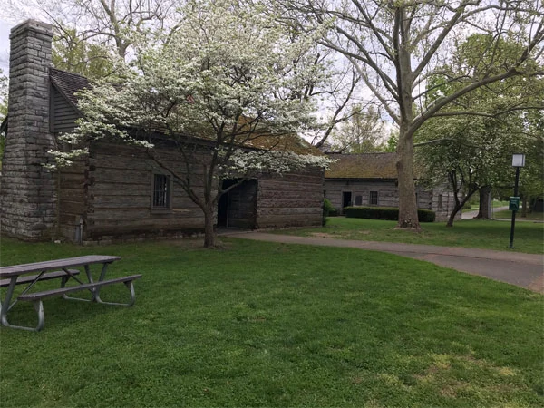 Pioneer-style log cabins on the green at Constitution Square Historic Site